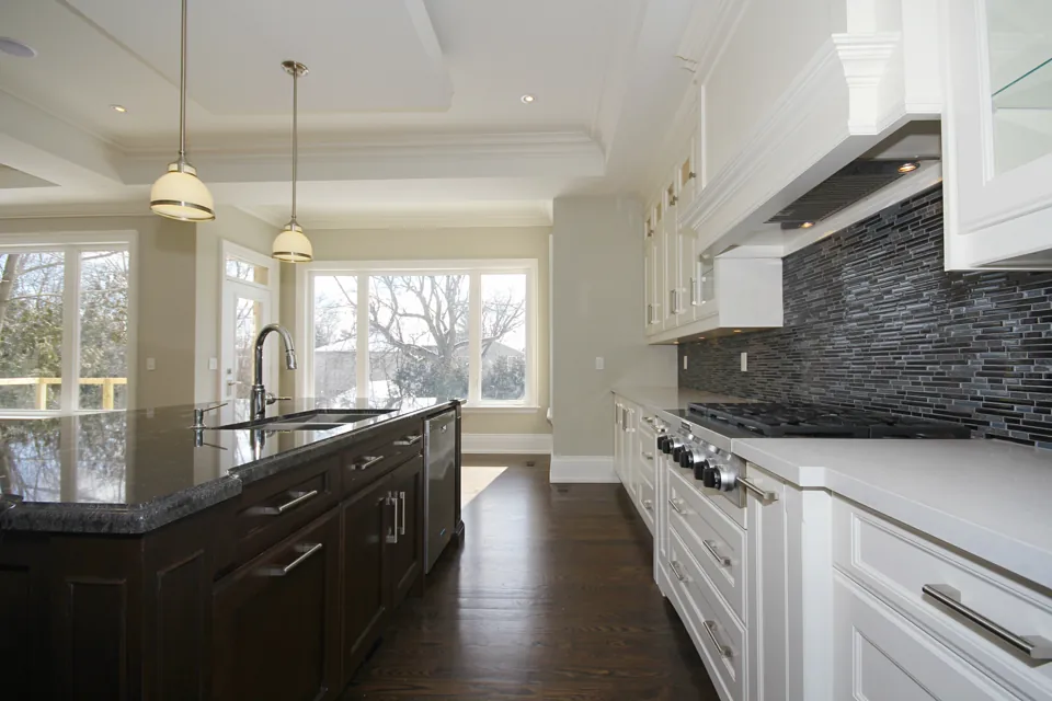 Classic kitchen with a dark island and bright windows